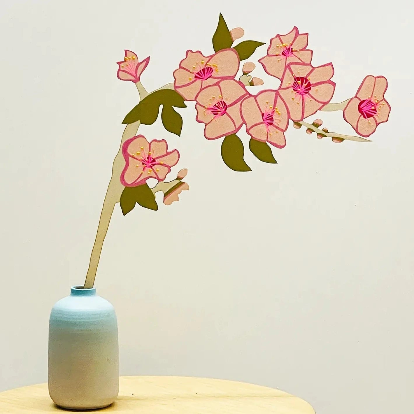  A beloved signal to the start of spring! A fluffy branch of pink cherry blossoms - all the pinks all the fluff.  Laser cut wood that is hand painted on both sides to resemble the real thing Approx 16" tall and 10" wideCosmic Peace Studio Forever Flower - Cherry Blossom Branch | Prelude & Dawn | Los Angeles, CA